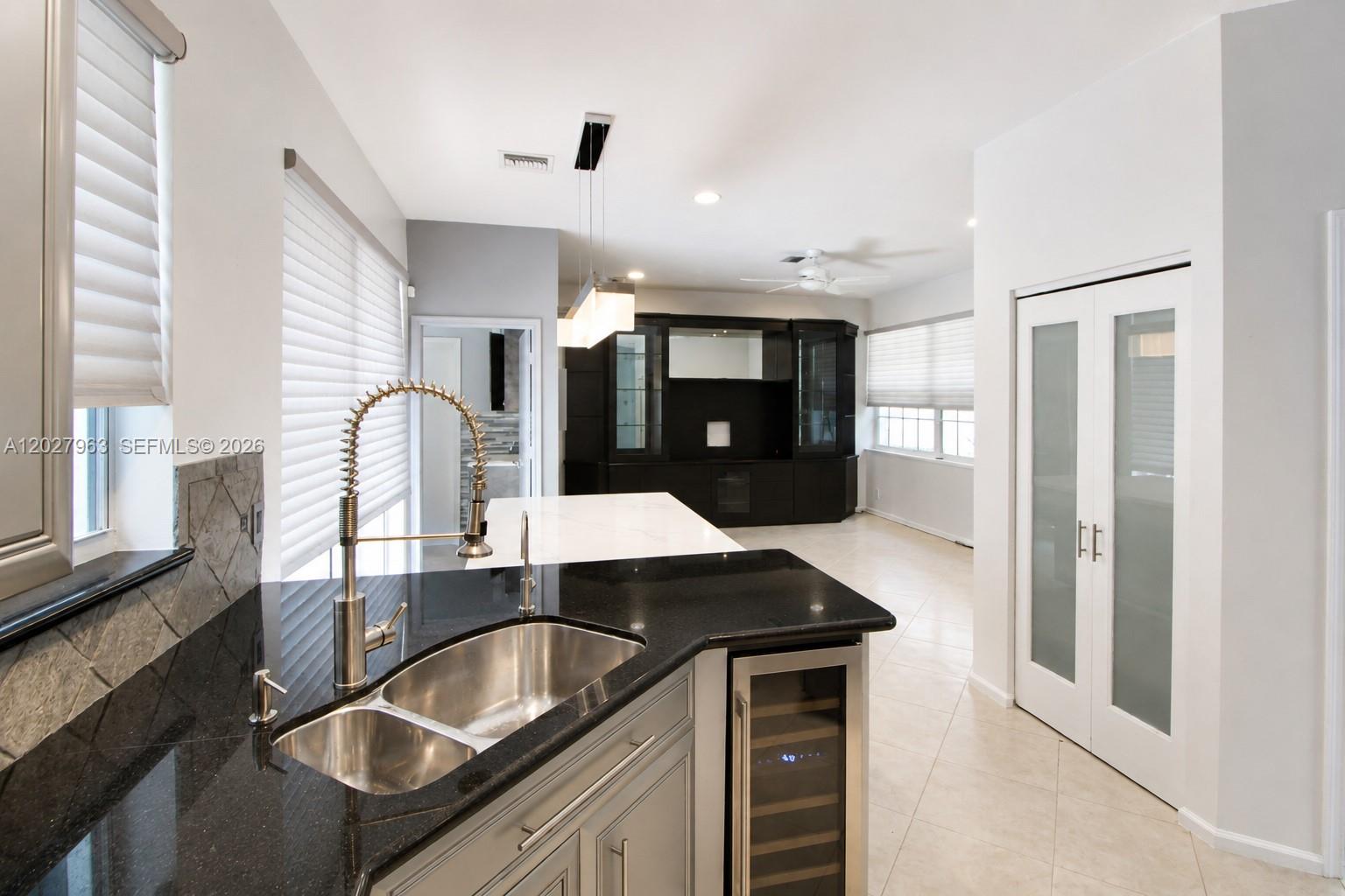 6646 Northwest 25th Terrace Boca Raton, FL 33496 - Photo 14 of 48 a kitchen with granite countertop a sink and cabinets