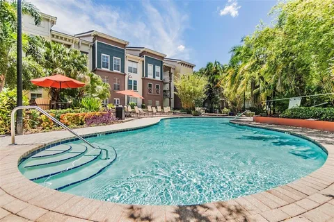 a view of a house with backyard sitting area and garden