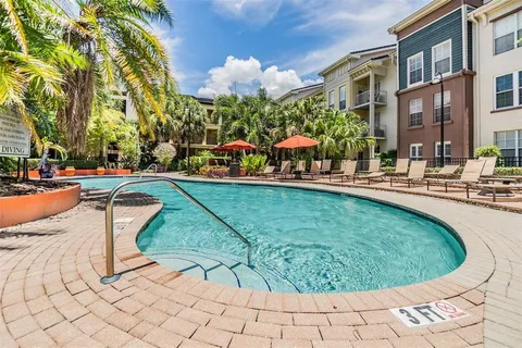 a swimming pool with outdoor seating and yard
