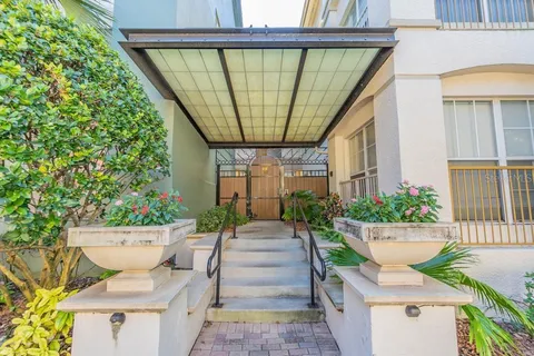 a view of a patio with table and chairs and potted plants
