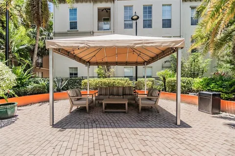 a view of a patio with a table and chairs under an umbrella