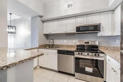 a kitchen with stainless steel appliances granite countertop a stove and a sink