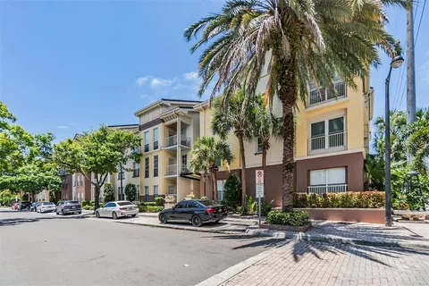 a front view of a building with tree s