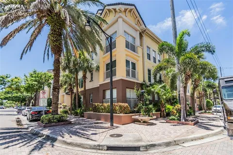 a view of a building with a yard and many windows