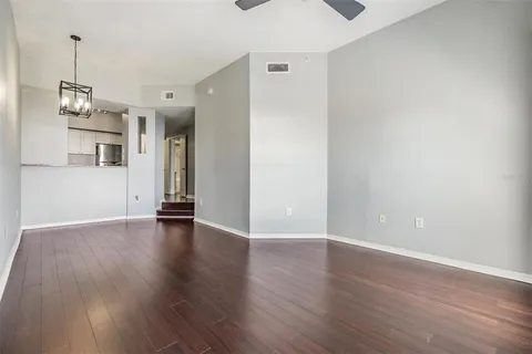 a view of a room with wooden floor and window