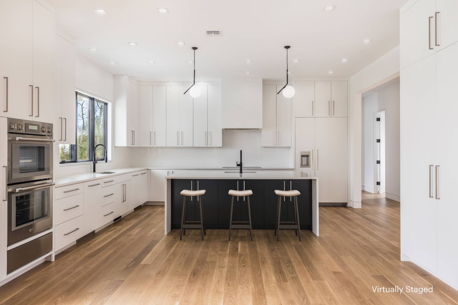 95 Highview Drive Sag Harbor, NY 11963 - Photo 5 of 22 a large kitchen with white cabinets a sink dishwasher a dining table and chairs with wooden floor
