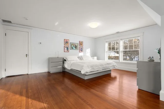 a bedroom with a large bed and a window