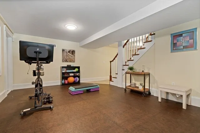 a kitchen with granite countertop white cabinets and refrigerator
