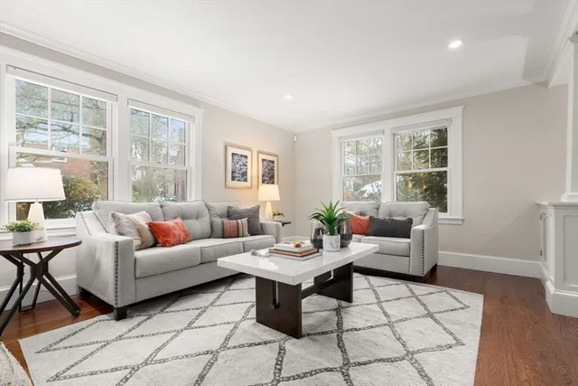 a living room with furniture and wooden floor
