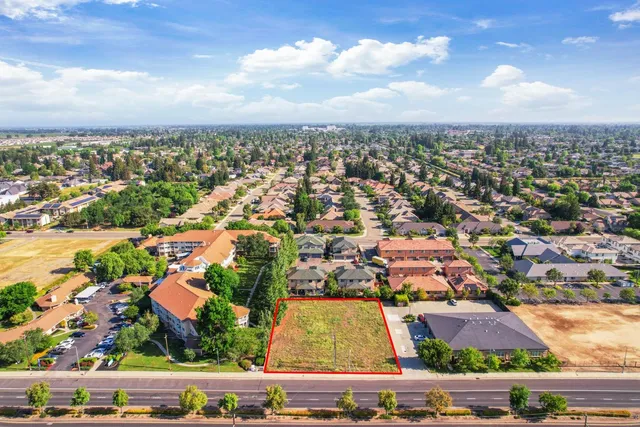 an aerial view of residential houses with city view