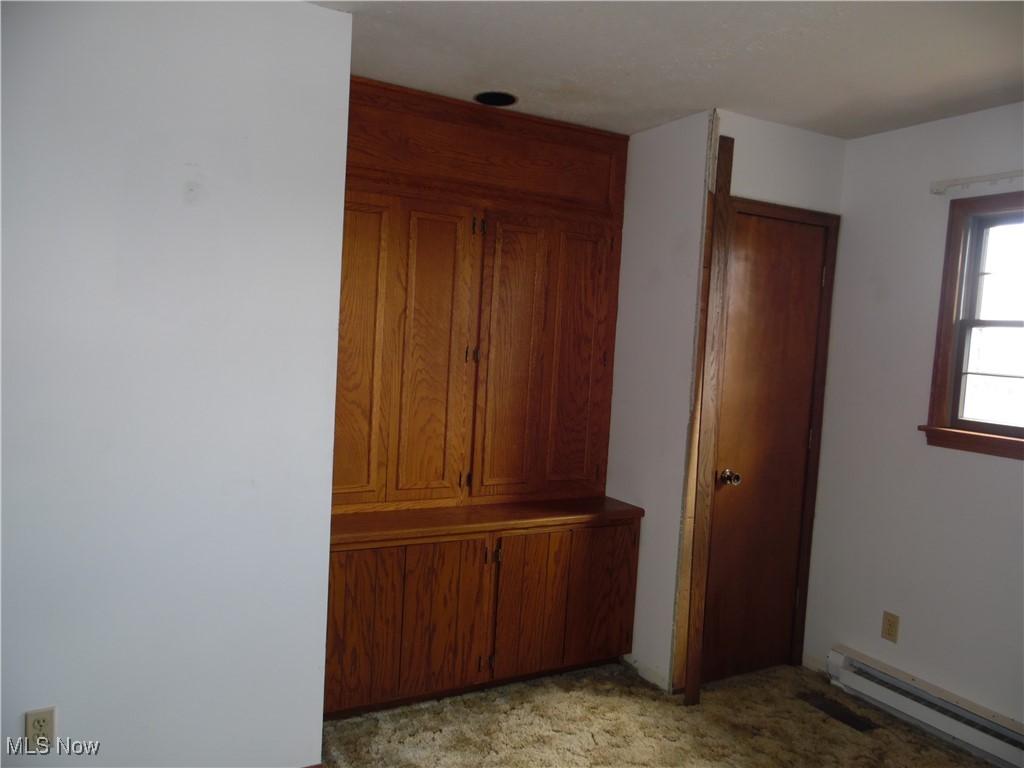 2800 Tick Ridge Road Lower Salem, OH 45745 - Photo 18 of 28 Unfurnished bedroom featuring a baseboard heating unit and light carpet