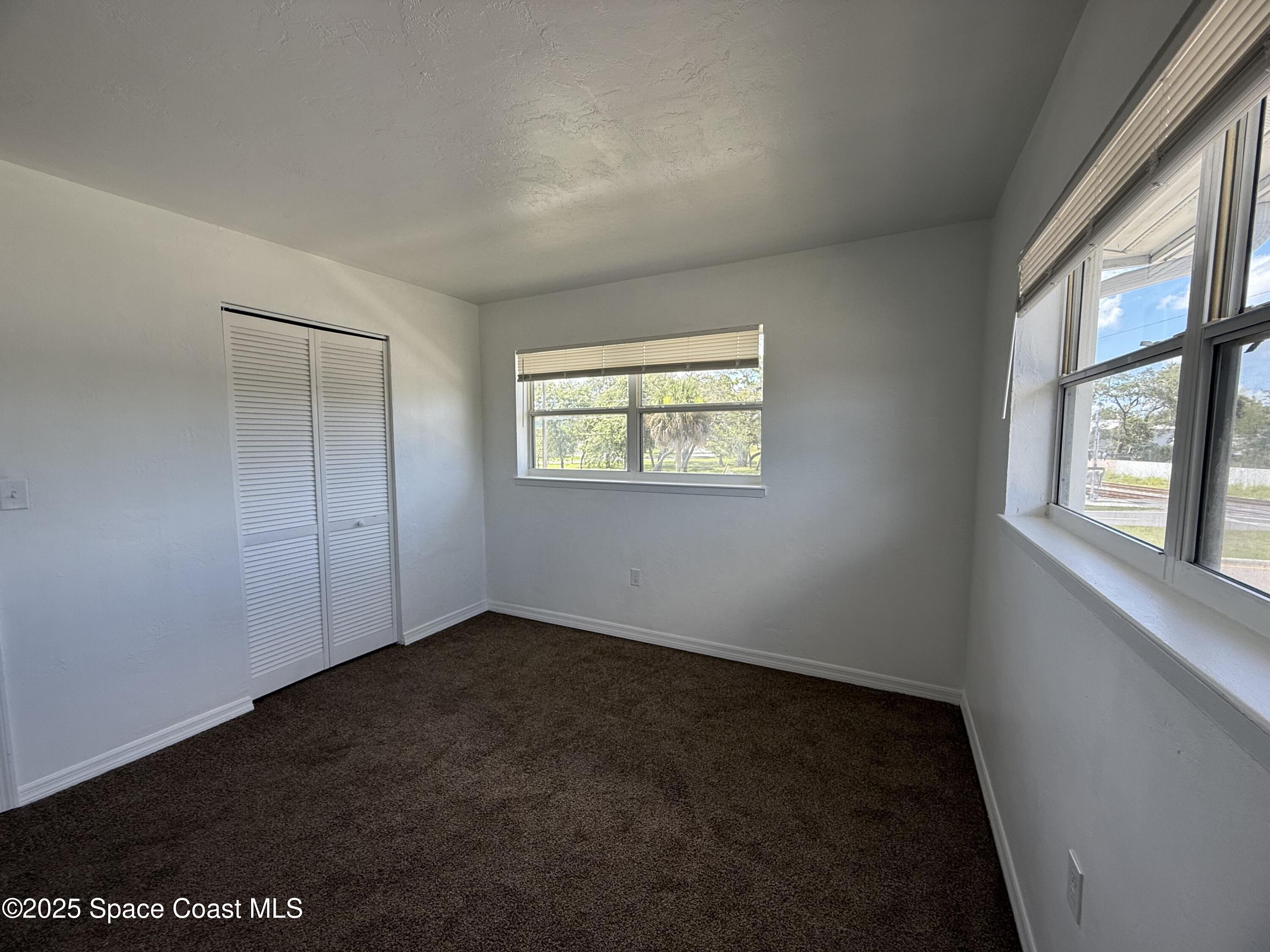 1440 Parkway Drive, Unit 7A Melbourne, FL 32935 - Photo 11 of 27 an empty room with windows