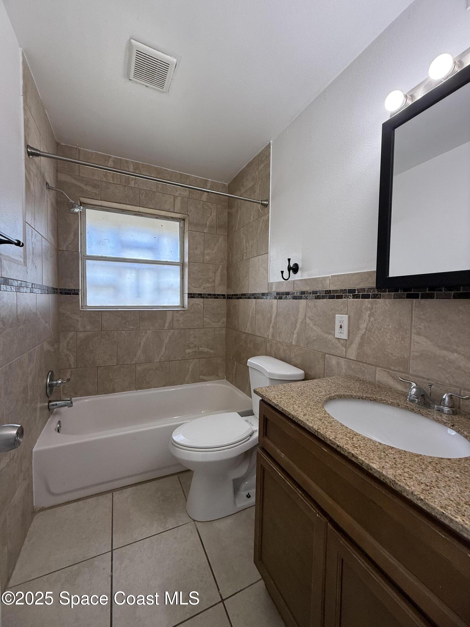 1440 Parkway Drive, Unit 7A Melbourne, FL 32935 - Photo 16 of 27 a bathroom with a sink a toilet and bathtub