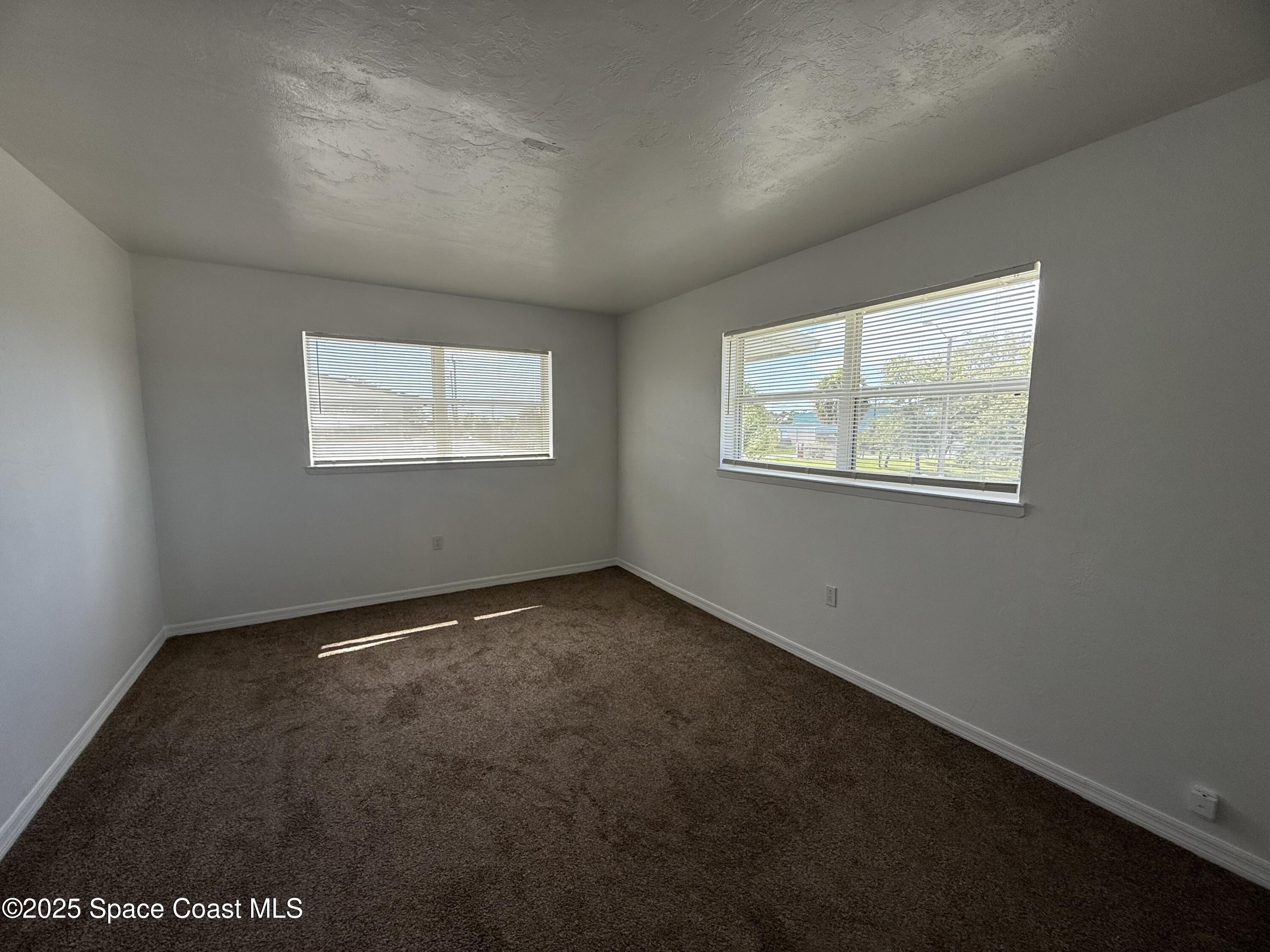 1440 Parkway Drive, Unit 7A Melbourne, FL 32935 - Photo 18 of 27 an empty room with windows