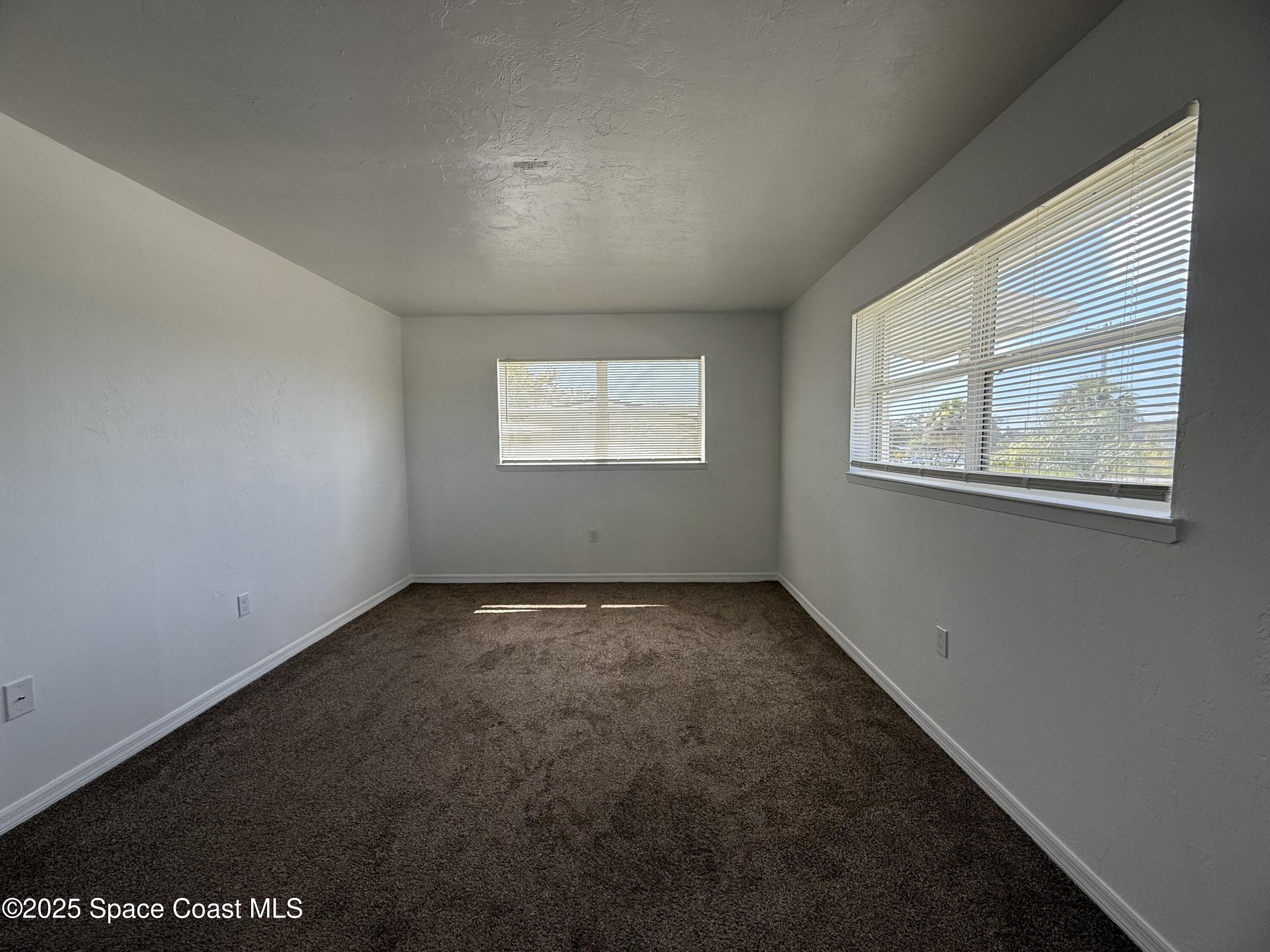 1440 Parkway Drive, Unit 7A Melbourne, FL 32935 - Photo 19 of 27 an empty room with windows