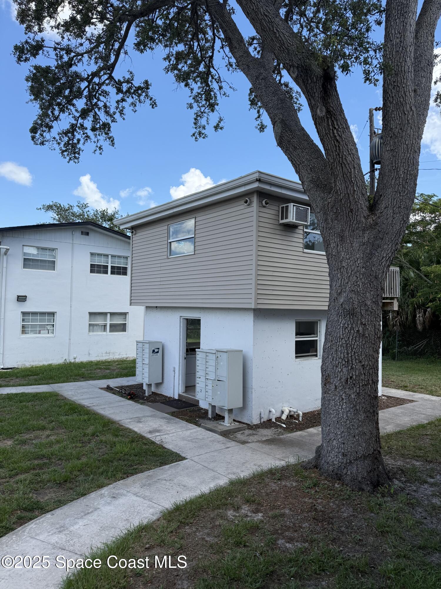 1440 Parkway Drive, Unit 7A Melbourne, FL 32935 - Photo 23 of 27 a front view of a house with a yard and garage