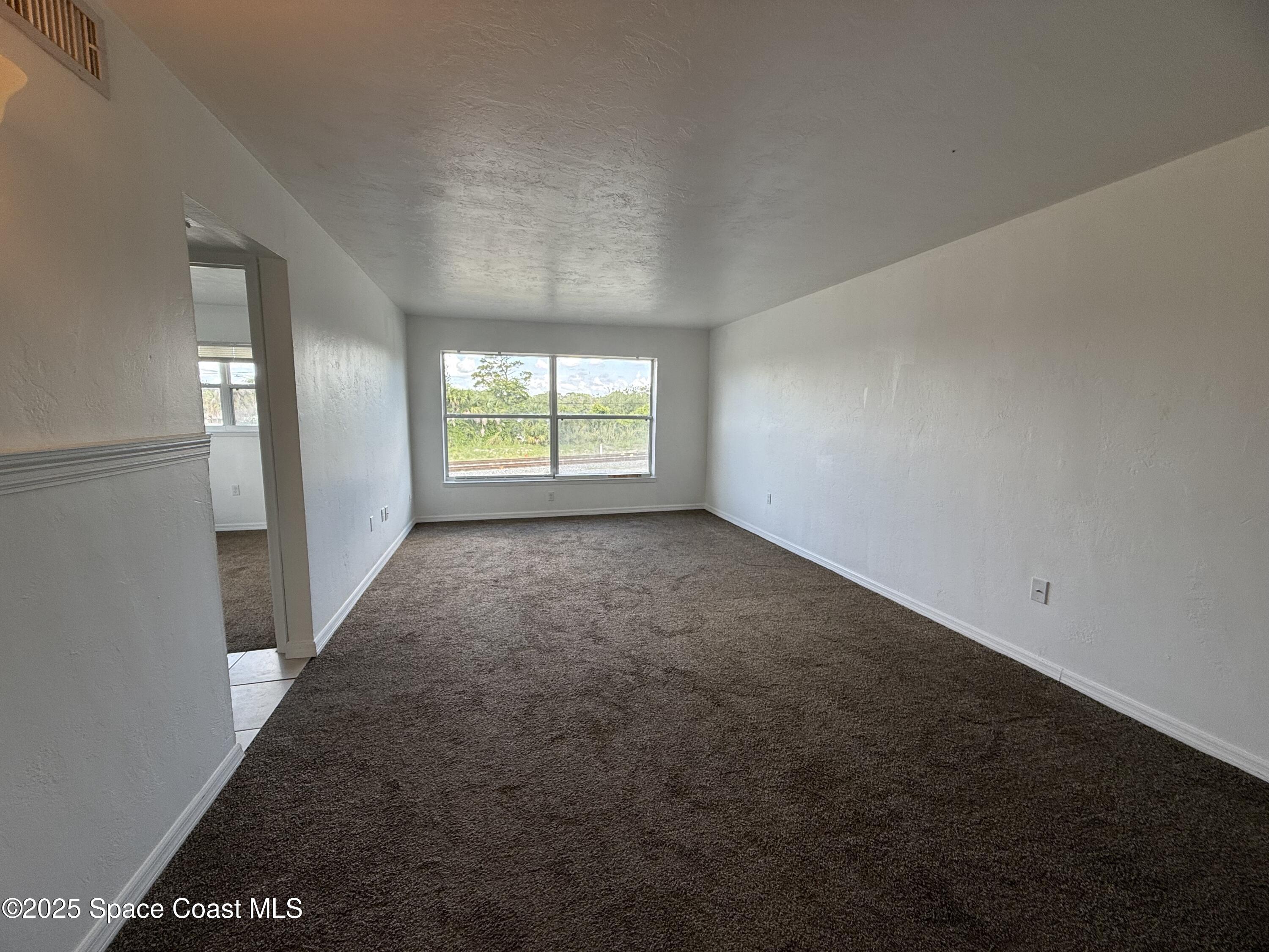 1440 Parkway Drive, Unit 7A Melbourne, FL 32935 - Photo 6 of 27 a view of an empty room with a window