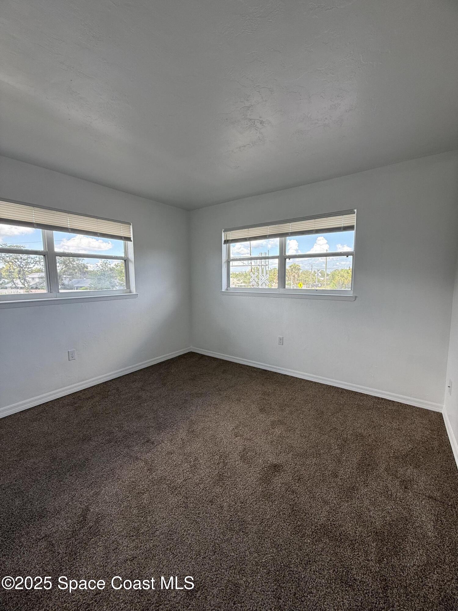 1440 Parkway Drive, Unit 7A Melbourne, FL 32935 - Photo 10 of 27 an empty room with windows