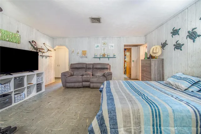 a bedroom with bed and flat screen tv