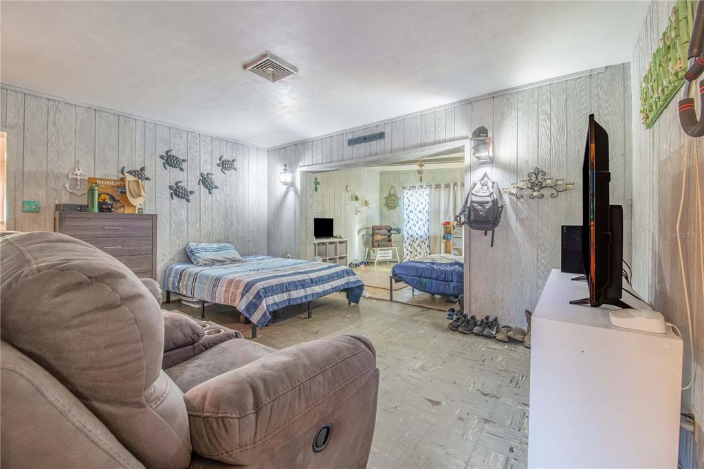 308 Granada Road Auburndale, FL 33823 - Photo 17 of 37 a bedroom with furniture and a flat screen tv