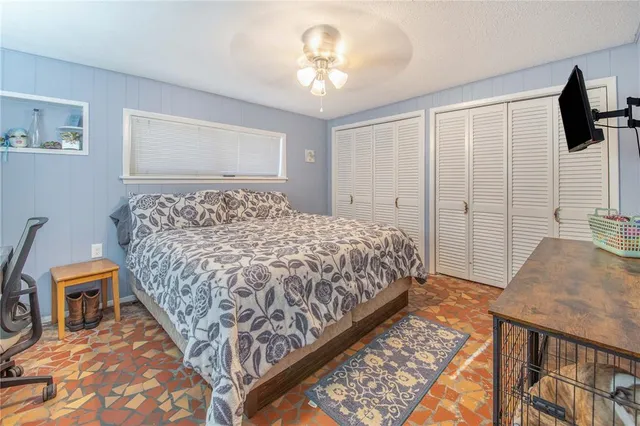 a bedroom with a bed and flat screen tv