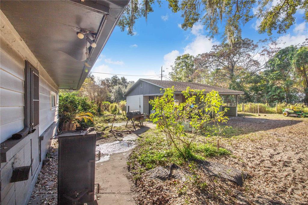 308 Granada Road Auburndale, FL 33823 - Photo 24 of 37 a view of a yard with plants and large trees