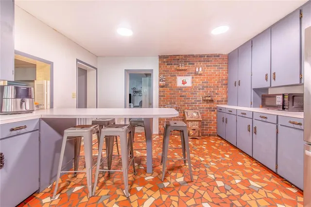 a kitchen with stainless steel appliances kitchen island granite countertop a stove a sink and cabinets