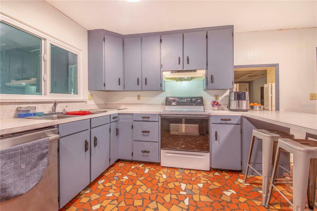 308 Granada Road Auburndale, FL 33823 - Photo 10 of 37 a kitchen with a stove a sink and a refrigerator