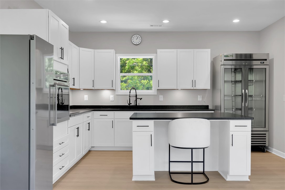 159 Cherokee Trail Easley, SC 29640 - Photo 12 of 38 A contemporary kitchen features bright white cabinetry and dark countertops, perfect for culinary adventures.