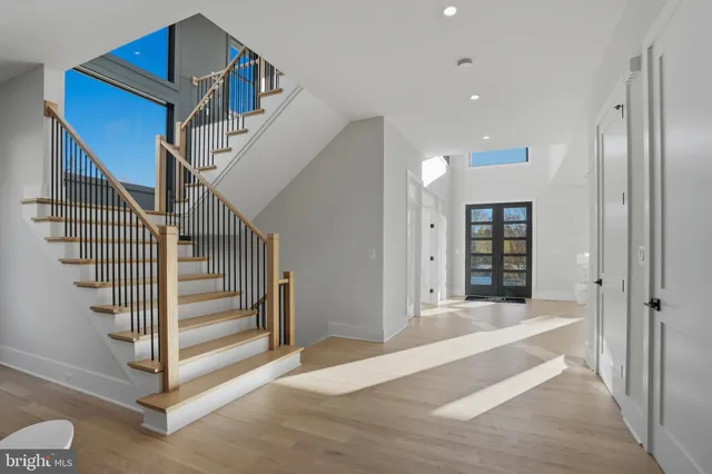 a large kitchen with a large counter top a sink stainless steel appliances and cabinets