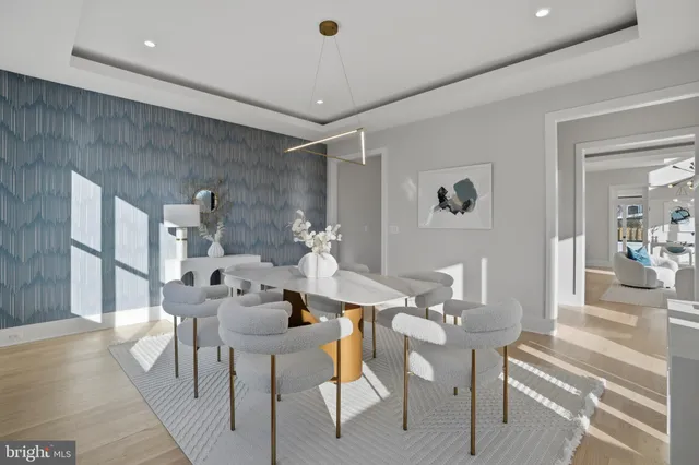 a large white kitchen with kitchen island a stove a sink a refrigerator and cabinets