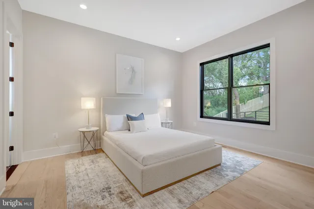 a living room with furniture a wooden floor and window