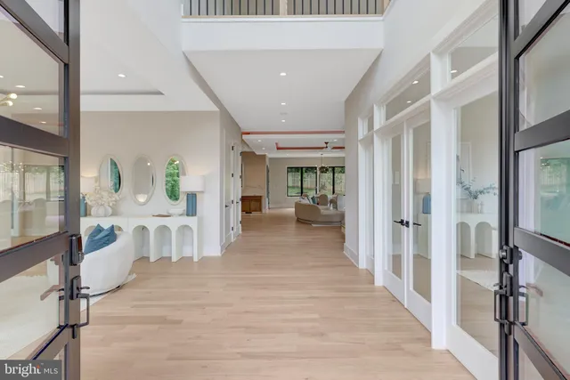 a living room with furniture a chandelier and a large window