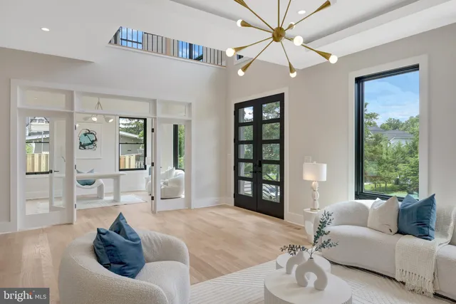 a large white kitchen with kitchen island a stove a sink a refrigerator and cabinets
