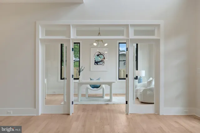 a large kitchen with stainless steel appliances kitchen island a large counter top a stove a chimney a sink and a refrigerator