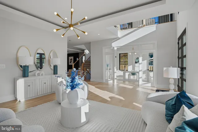 a large kitchen with a large counter top a sink stainless steel appliances and cabinets