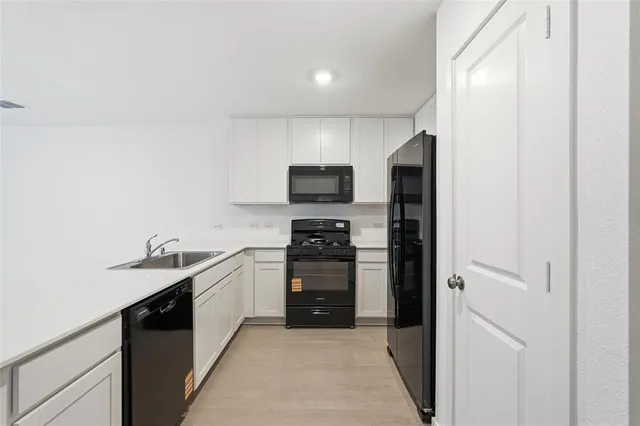 a kitchen with a sink and stainless steel appliances