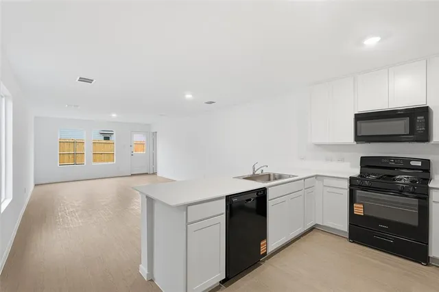 a kitchen with sink and cabinets