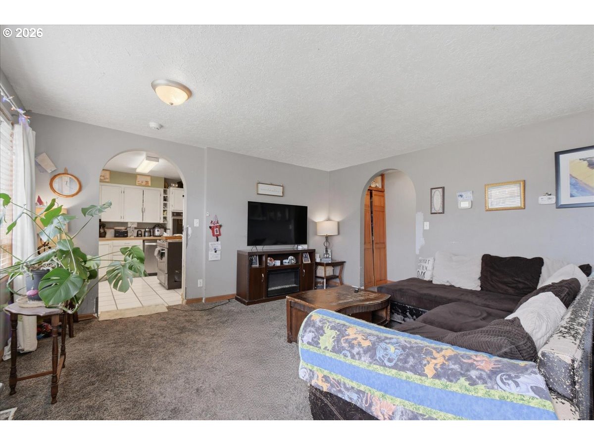 3287 Olive Way Longview, WA 98632 - Photo 4 of 24 a living room with furniture a flat screen tv and a dining table