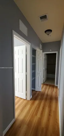 a view of empty room with closet and bathroom