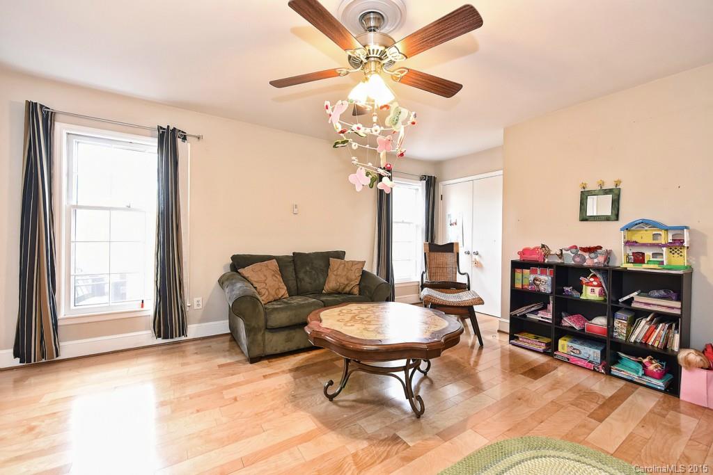 646 Sandridge Road Charlotte, NC 28210 - Photo 13 of 24 a living room with furniture a piano and a bookshelf