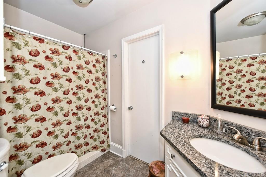 646 Sandridge Road Charlotte, NC 28210 - Photo 14 of 24 a bathroom with a granite countertop sink and a mirror