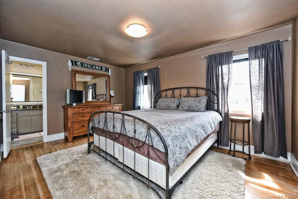 646 Sandridge Road Charlotte, NC 28210 - Photo 16 of 24 a bedroom with a large bed and a dresser