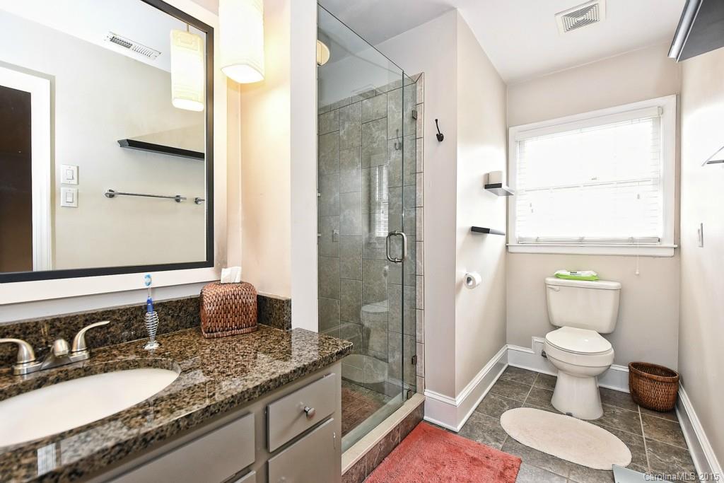 646 Sandridge Road Charlotte, NC 28210 - Photo 17 of 24 a bathroom with a granite countertop sink toilet a mirror and shower
