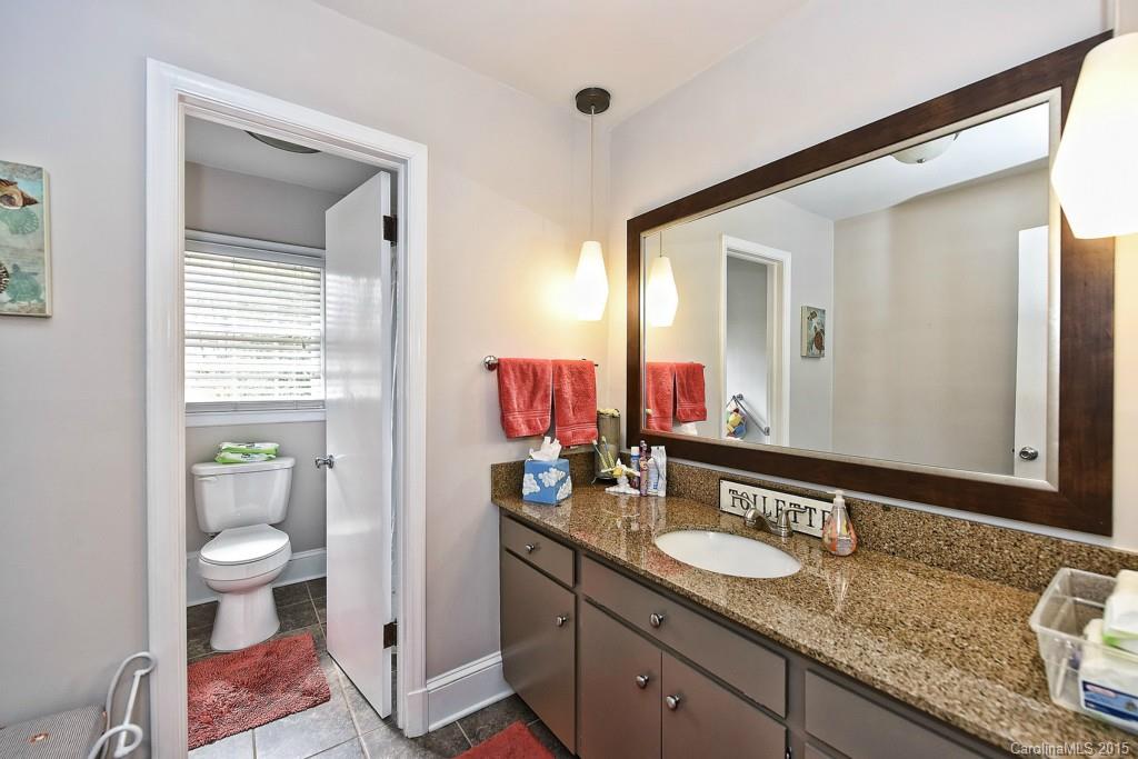 646 Sandridge Road Charlotte, NC 28210 - Photo 21 of 24 a bathroom with a granite countertop sink and a mirror