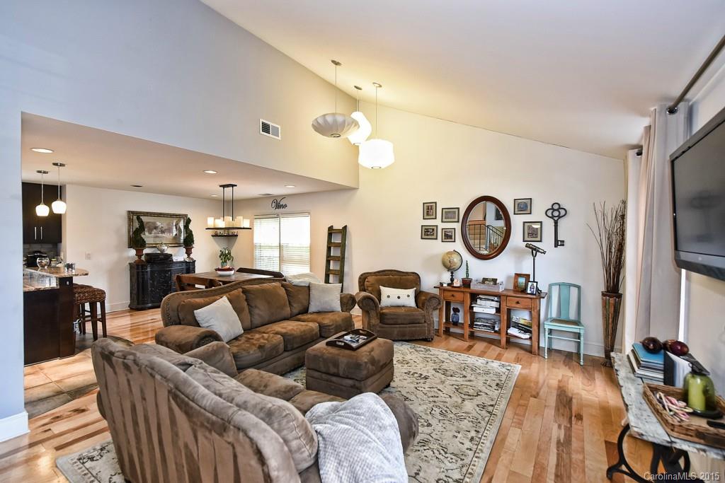 646 Sandridge Road Charlotte, NC 28210 - Photo 5 of 24 a living room with furniture a flat screen tv and kitchen view
