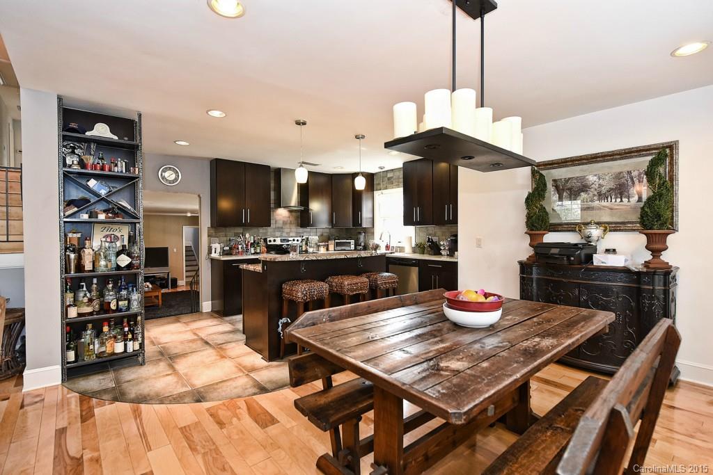 646 Sandridge Road Charlotte, NC 28210 - Photo 7 of 24 a kitchen with stainless steel appliances kitchen island granite countertop a table chairs and a refrigerator