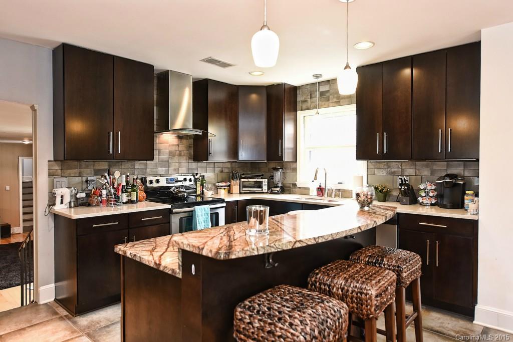 646 Sandridge Road Charlotte, NC 28210 - Photo 8 of 24 a kitchen with a sink and a stove top oven with wooden floor