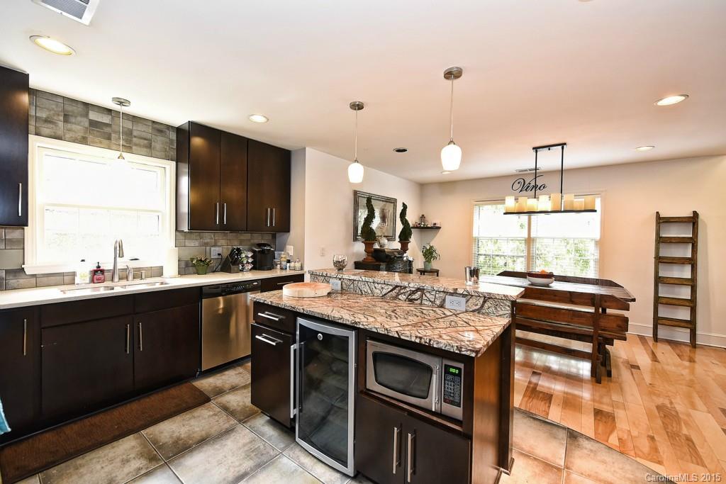 646 Sandridge Road Charlotte, NC 28210 - Photo 9 of 24 a kitchen with stainless steel appliances granite countertop a stove a sink and a microwave