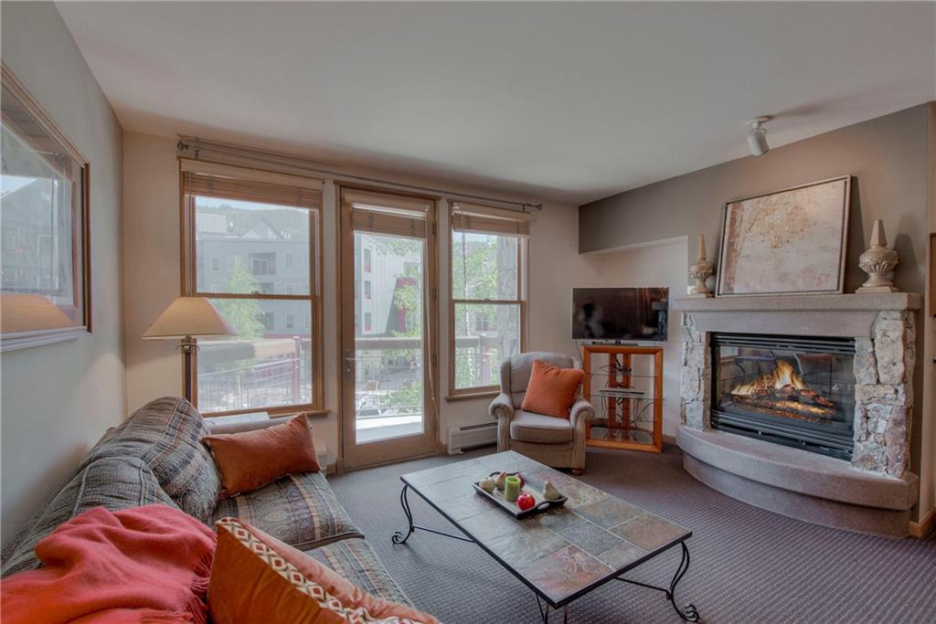 129 River Run Road, Unit 8062 Dillon, CO 80435 - Photo 1 of 35 a living room with furniture and a fireplace